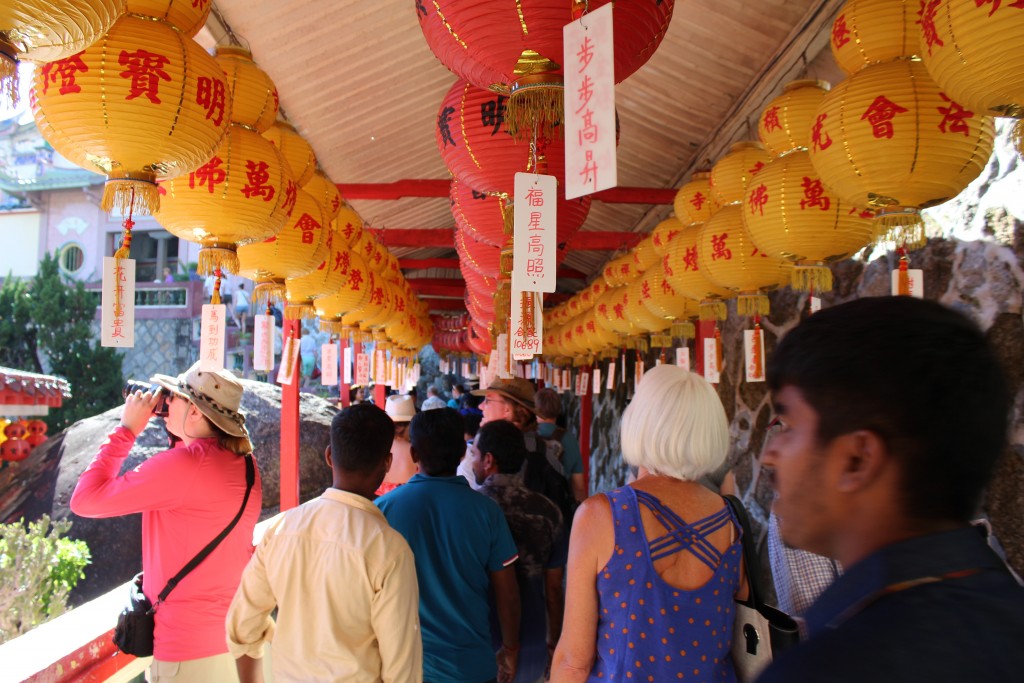Navigating a passageway bedecked with lanterns for Chinese New Year.