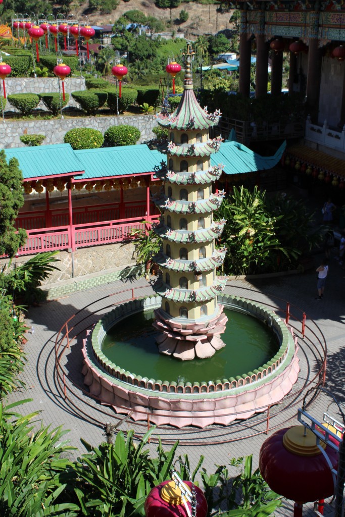 A pagoda tower surrounded by a pool.