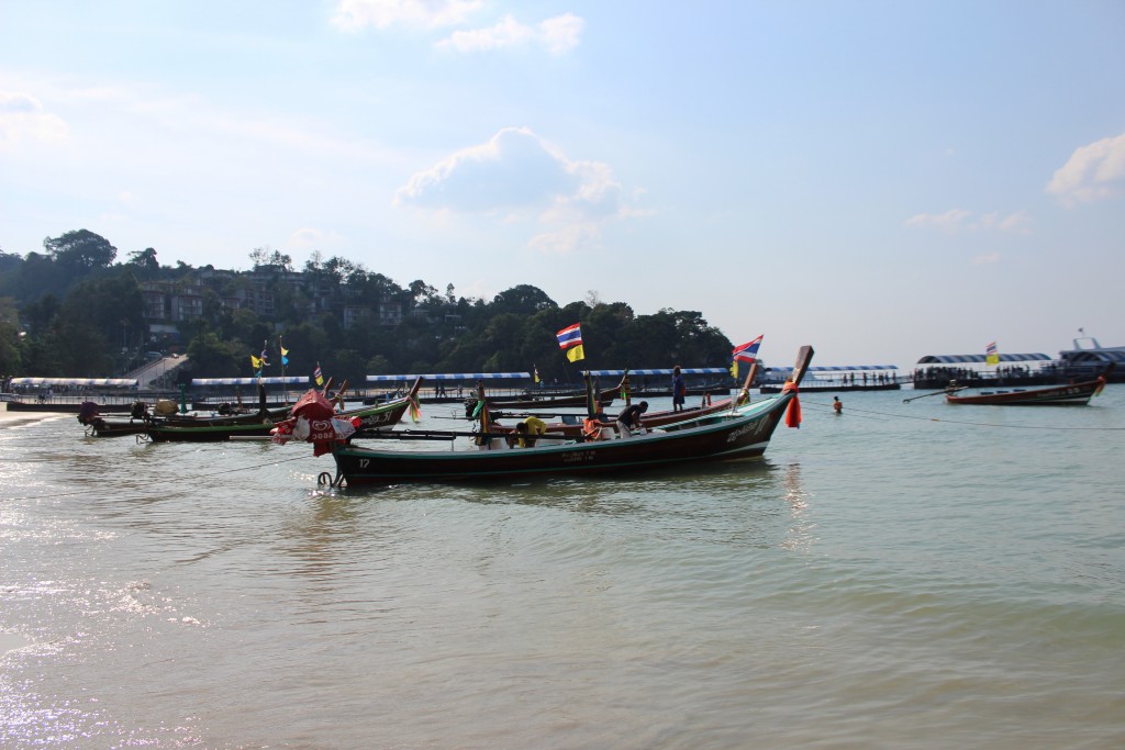 Long-tailed boats for hire wait for customers along the beach at Patong.