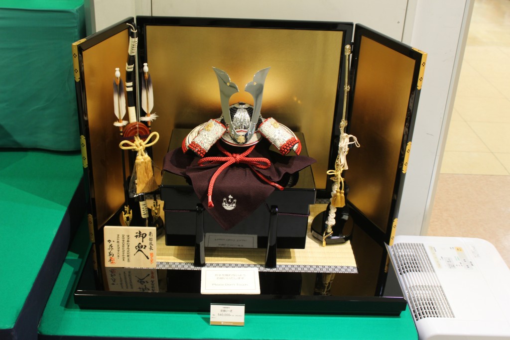 A helmet, a bow and arrow, and a kitana sword fill this shrine.