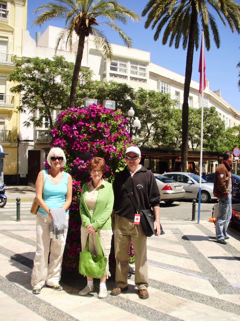 Janis and our friends Chris and Sheila in front of a gorgeous planter in Cadiz.
