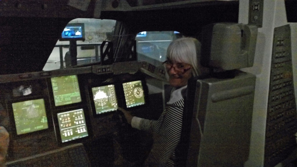 My wife the astronaut! Janis takes the pilot seat in this cockpit mock-up.