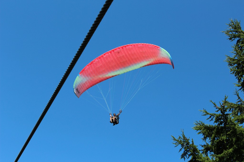 As we go up the chairlift, a hang glider flies over.