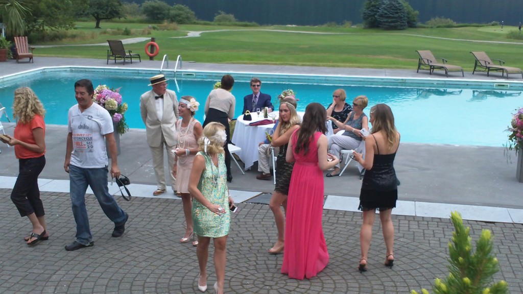 A number of people mingled at poolside